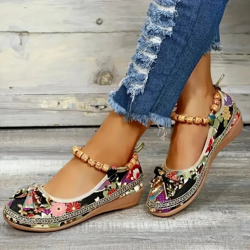 Women's plus size black ethnic platform sandals with elastic band and cloth upper.