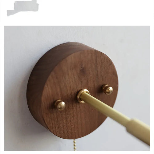 Nordic-style wooden wall lamp mounted beside a bed, shown in walnut brown and natural wood colour options.