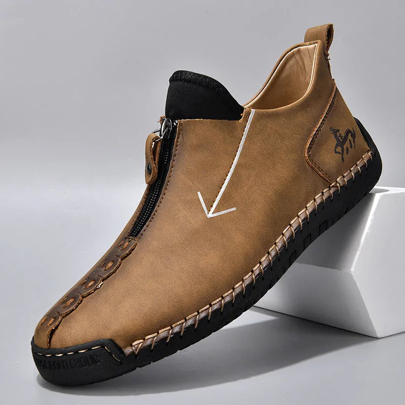 Men's black casual ankle boots with a front zip closure and visible stitching detail
