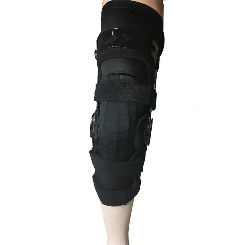 Black anterior ligament knee pad with adjustable straps shown from side view