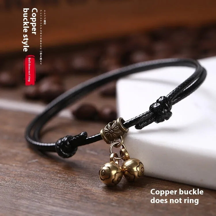 Small dog wearing adjustable nylon rope collar with brass bell in black, red or coffee colour
