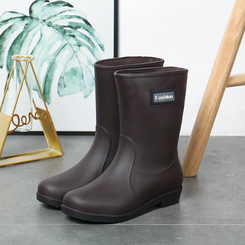 Women's black PVC rain boots with mid-calf height and low heel