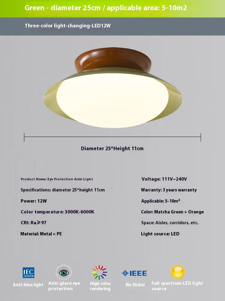 Modern flying saucer shaped ceiling lamp with an iron shade, shown in a cream yellow finish.