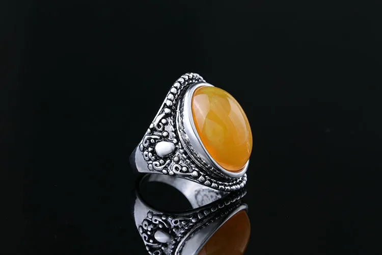 Geometric antique silver amber alloy ring with retro design on a hand.