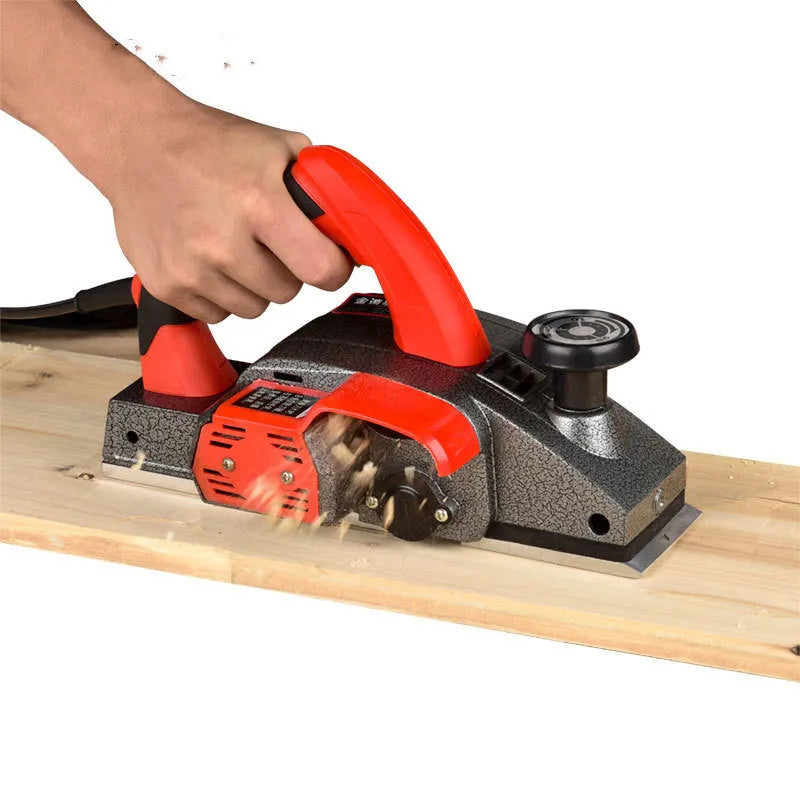 Red electric wood planer tool with aluminium shell showing 82mm cutting width
