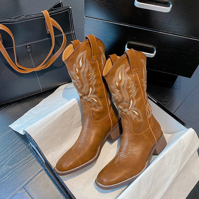 Brown women's mid-calf Martin boots with embroidered pattern, leather lining, and a square rubber sole.
