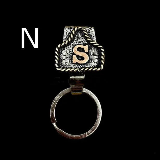 Handmade metal cow tag belt key holder keychain on a key ring, showing the metal loop and tag design.