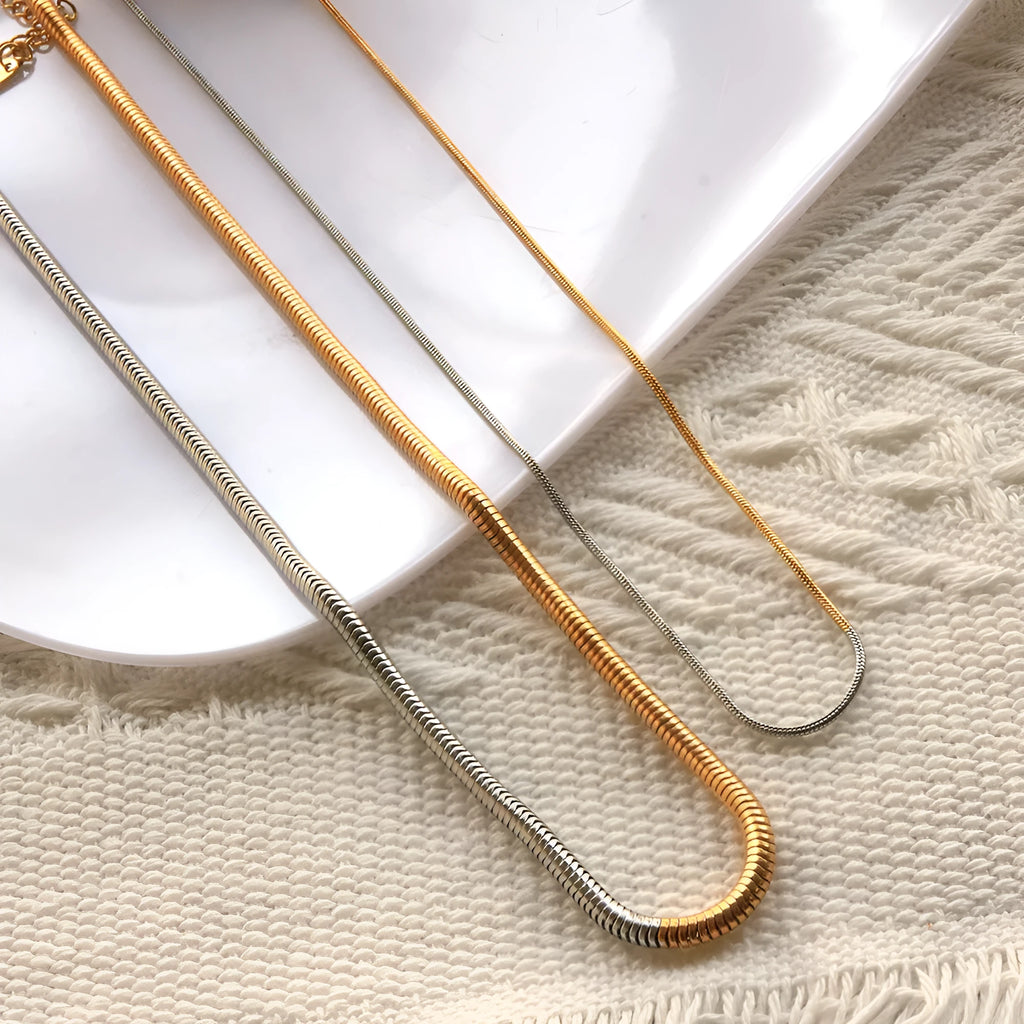 Golden stainless steel snake bone chain necklace with geometric line design