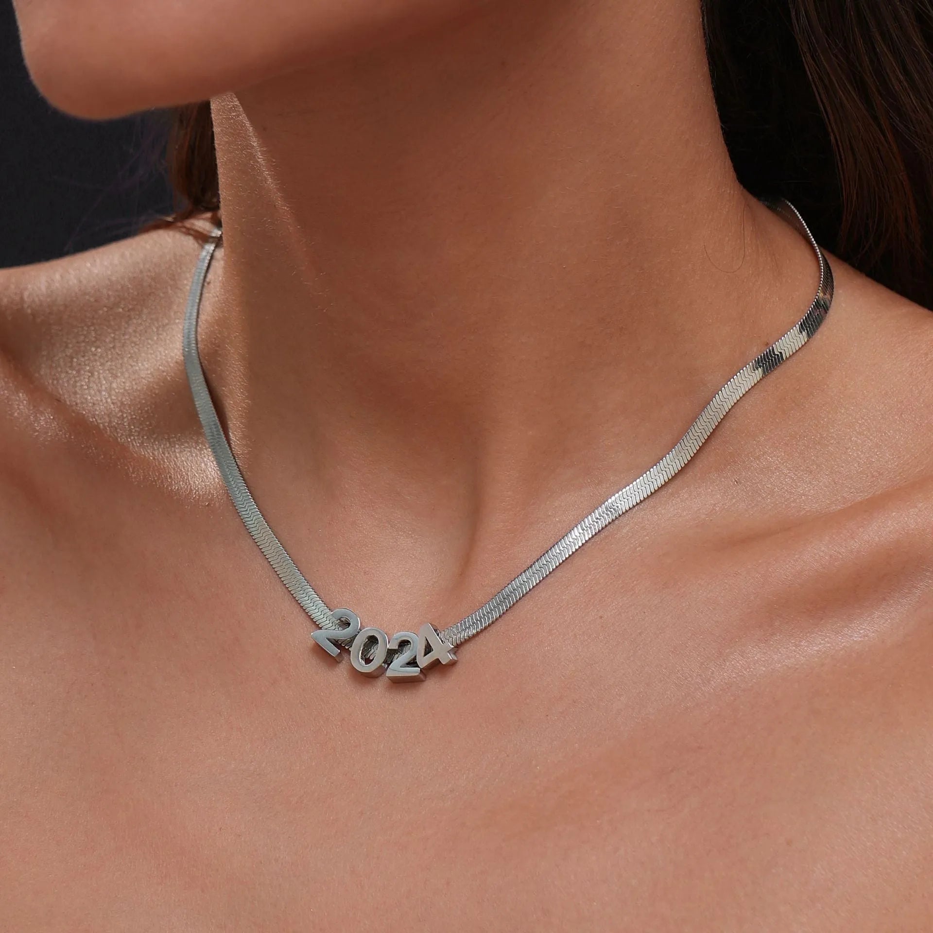 Gold and silver titanium steel necklaces showing letter A and number 7 pendants on 40.5cm chains.