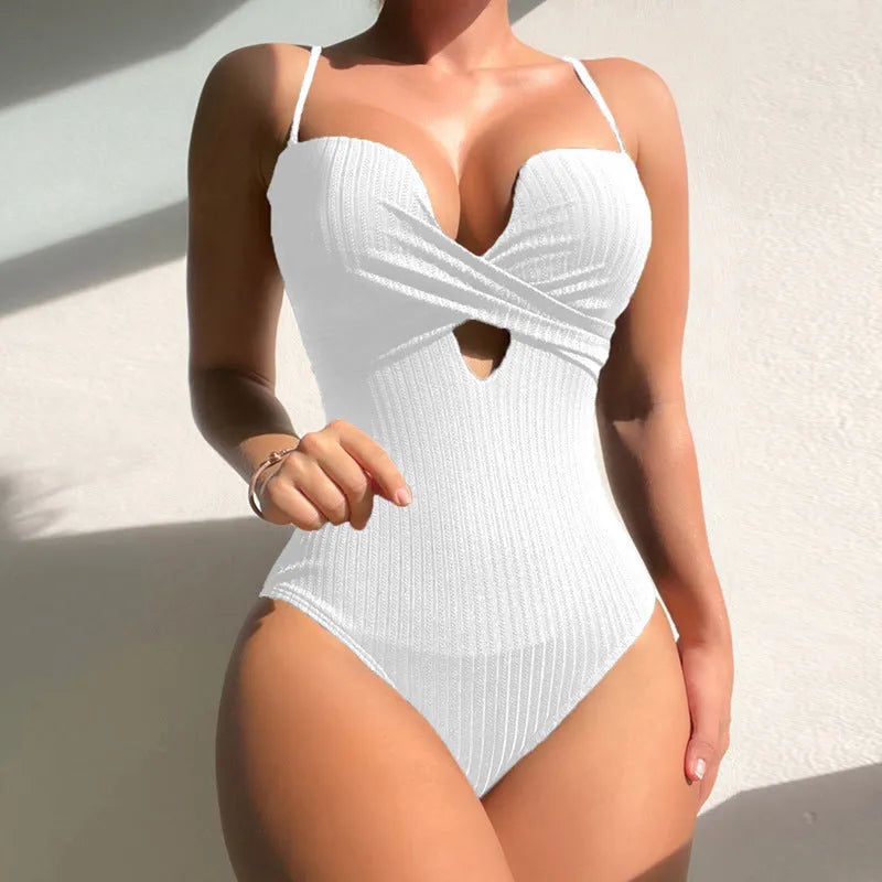 Women's solid colour one-piece swimsuit in white on a mannequin, showing the slimming silhouette.