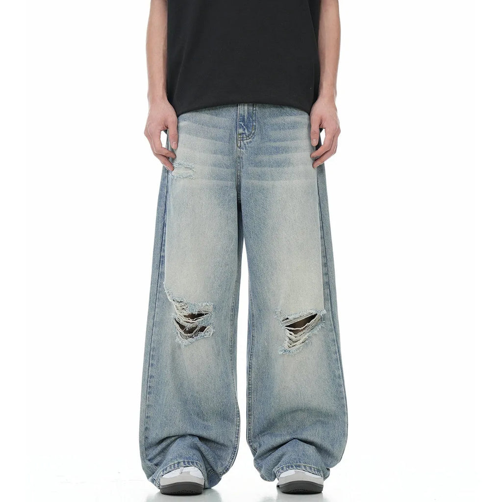 Blue wash straight-leg jeans with ripped detailing and zipper fly opening