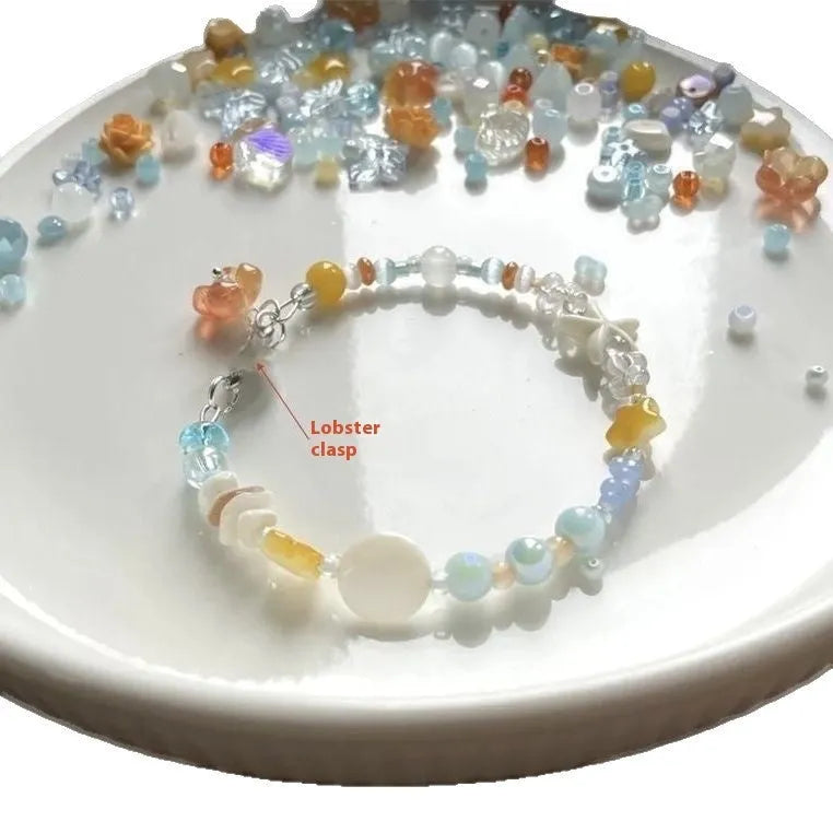 Orange summer bracelet with diamond-shaped alloy charm and round elements on mixed-material band