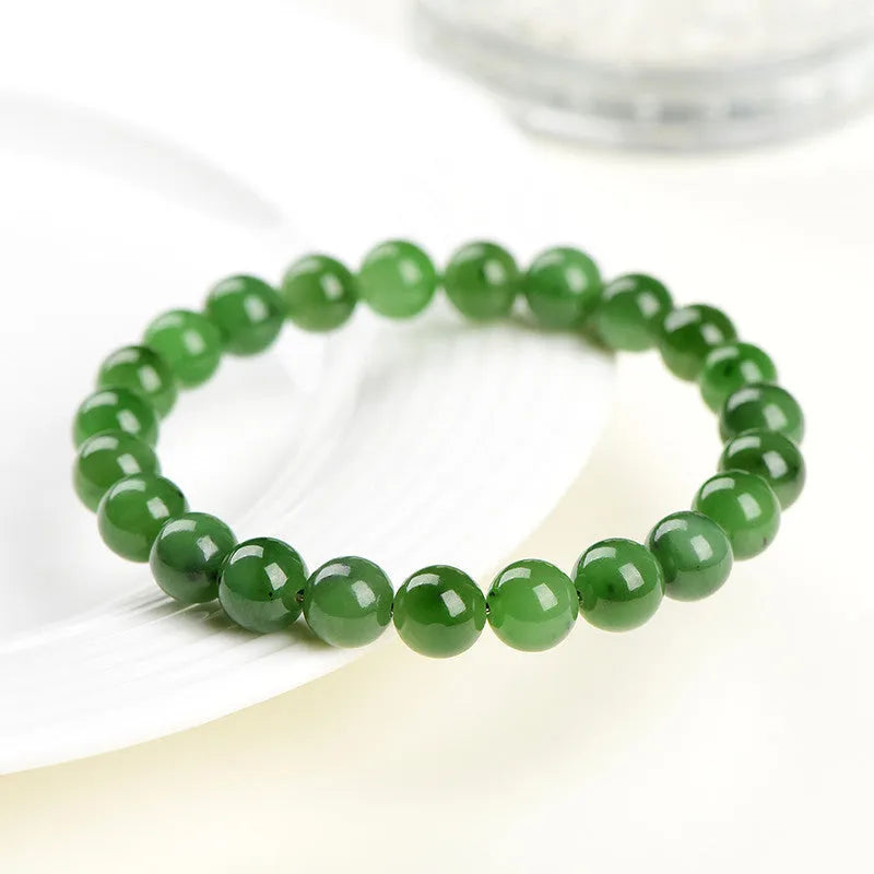 Polished Hetian jade jasper ball bracelet showing natural stone beads in multiple size options on a wrist.