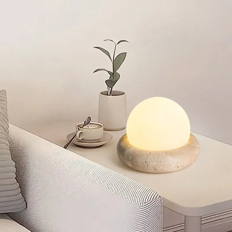 Cream colour bedside night lamp with remote control on wooden bedside table