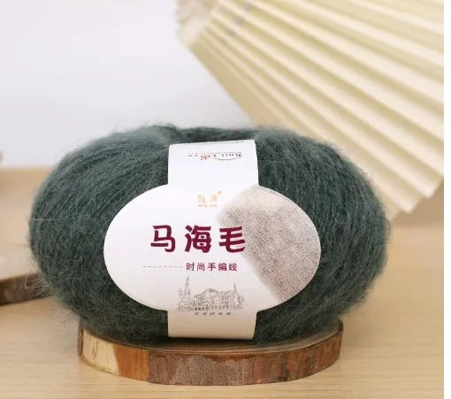 DIY mohair scarf weaving kit showing one wool ball and a selection of 34 colour options including white, pink, blue and green.