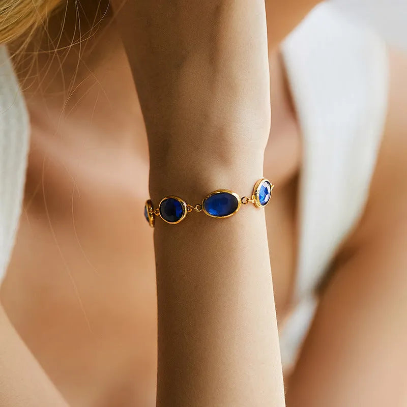 Women's 18K copper geometric ellipse bracelet with blue green multicolor glass inlay detailing