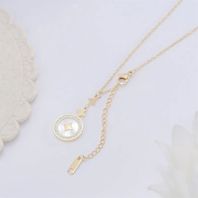 Gold six-pointed star titanium steel necklace on a model, showing the geometric pendant and O-ring chain.