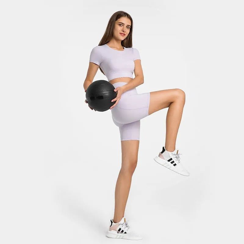 Women's tight-fitting mid-length sport shorts in black cotton blend fabric.