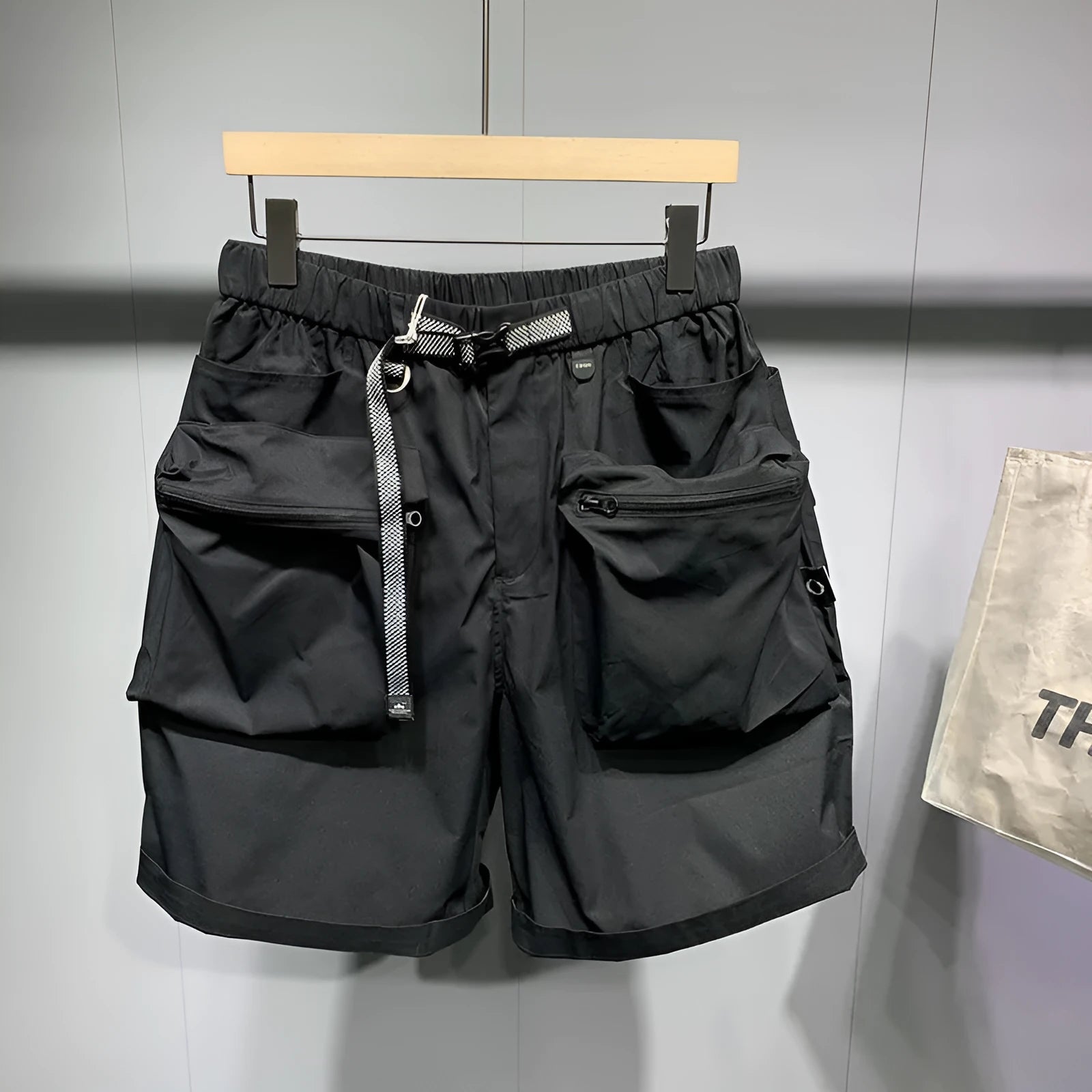 Men's black loose fitting work shorts with multiple pockets and straight leg hem