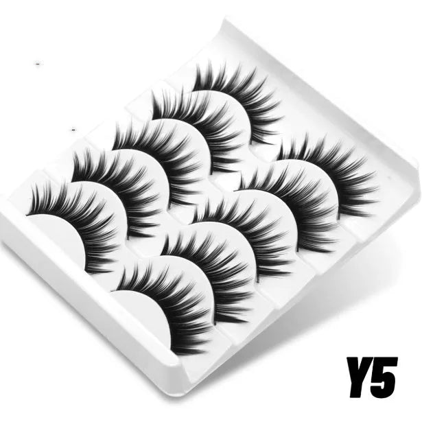 Box of natural style false eyelashes made from artificial fibre, includes adhesive glue