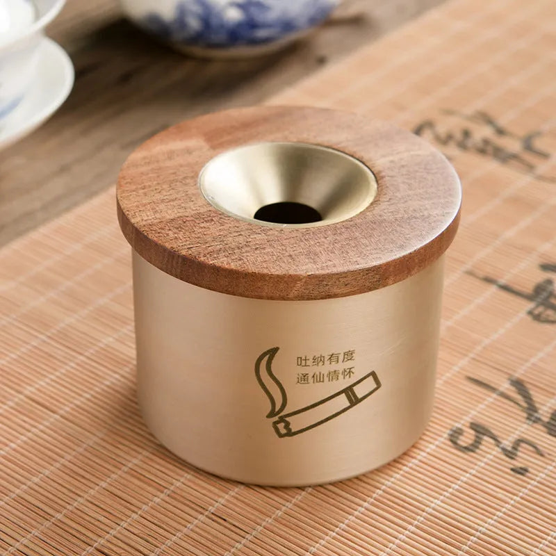 Retro-style brass ashtray with a wooden lid, shown in a home living room setting.