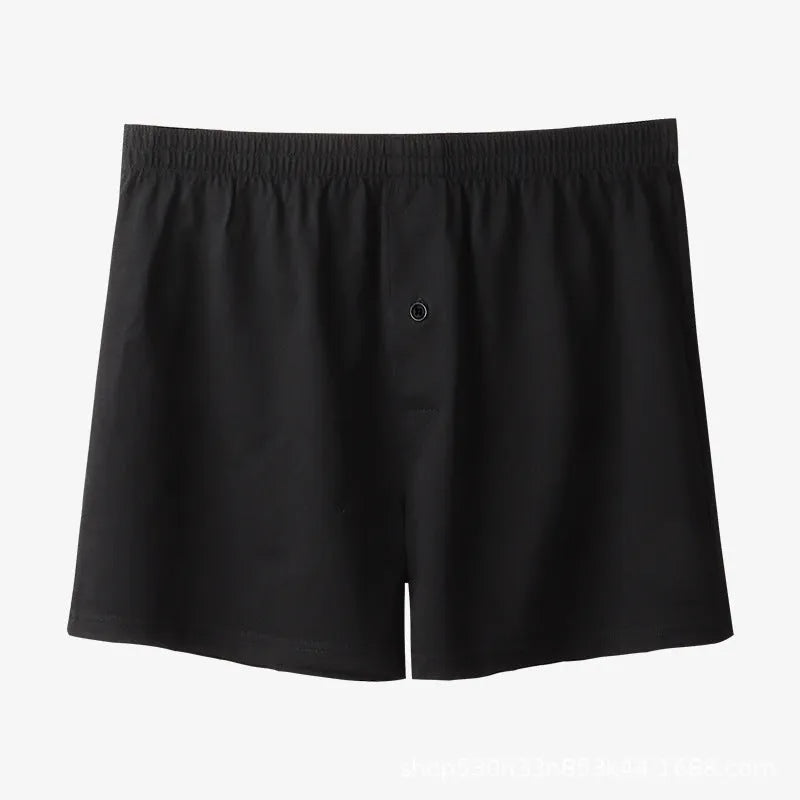 Men's solid colour loose-fit cotton boxer shorts on a white background, showing high waist and leg openings.