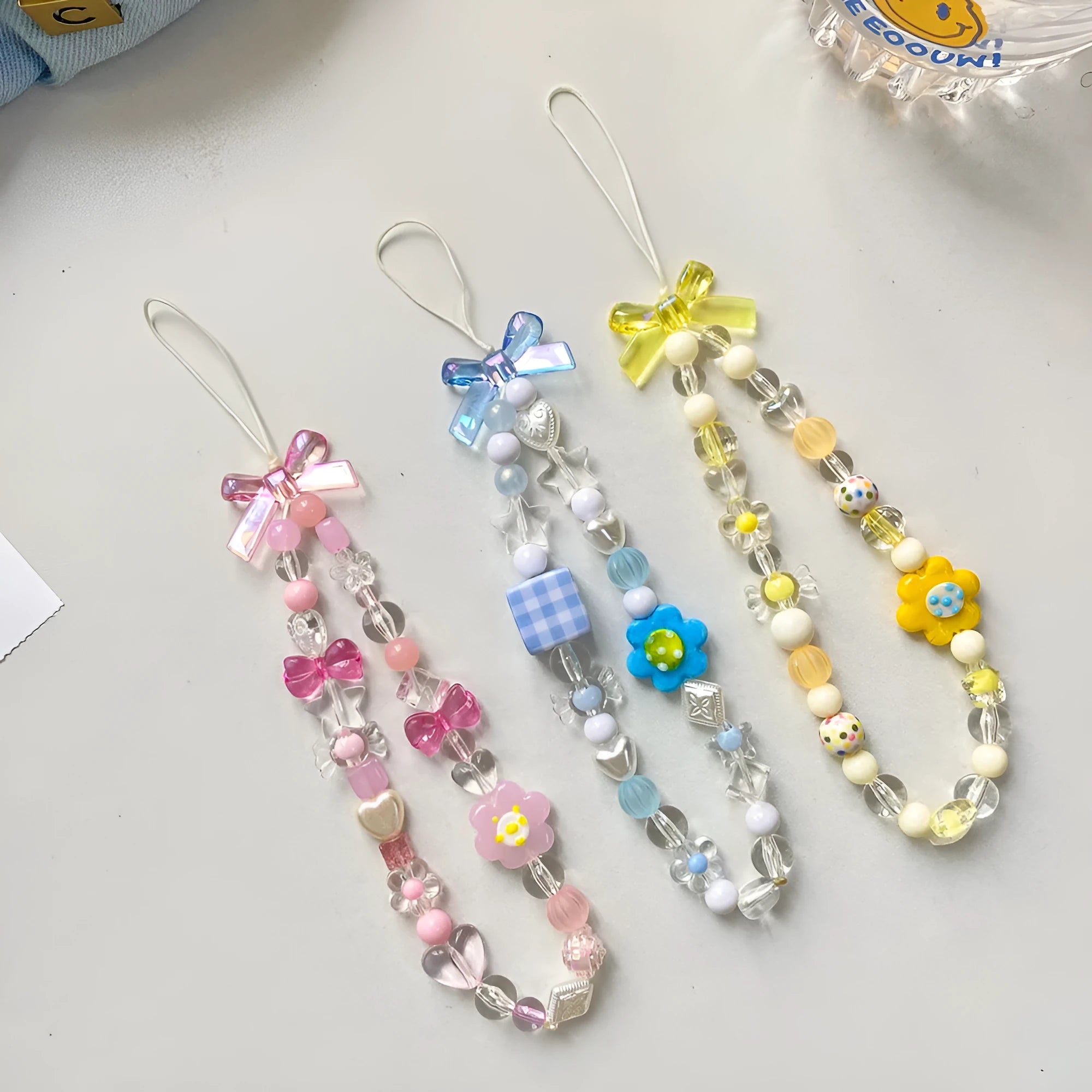 Colourful beaded flower mobile phone lanyard with adjustable hand rope in yellow, blue or pink