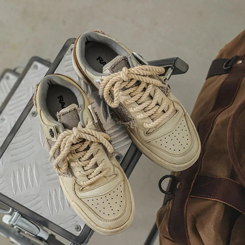 Beige low-top vintage skateboard shoes with round toe and rubber sole