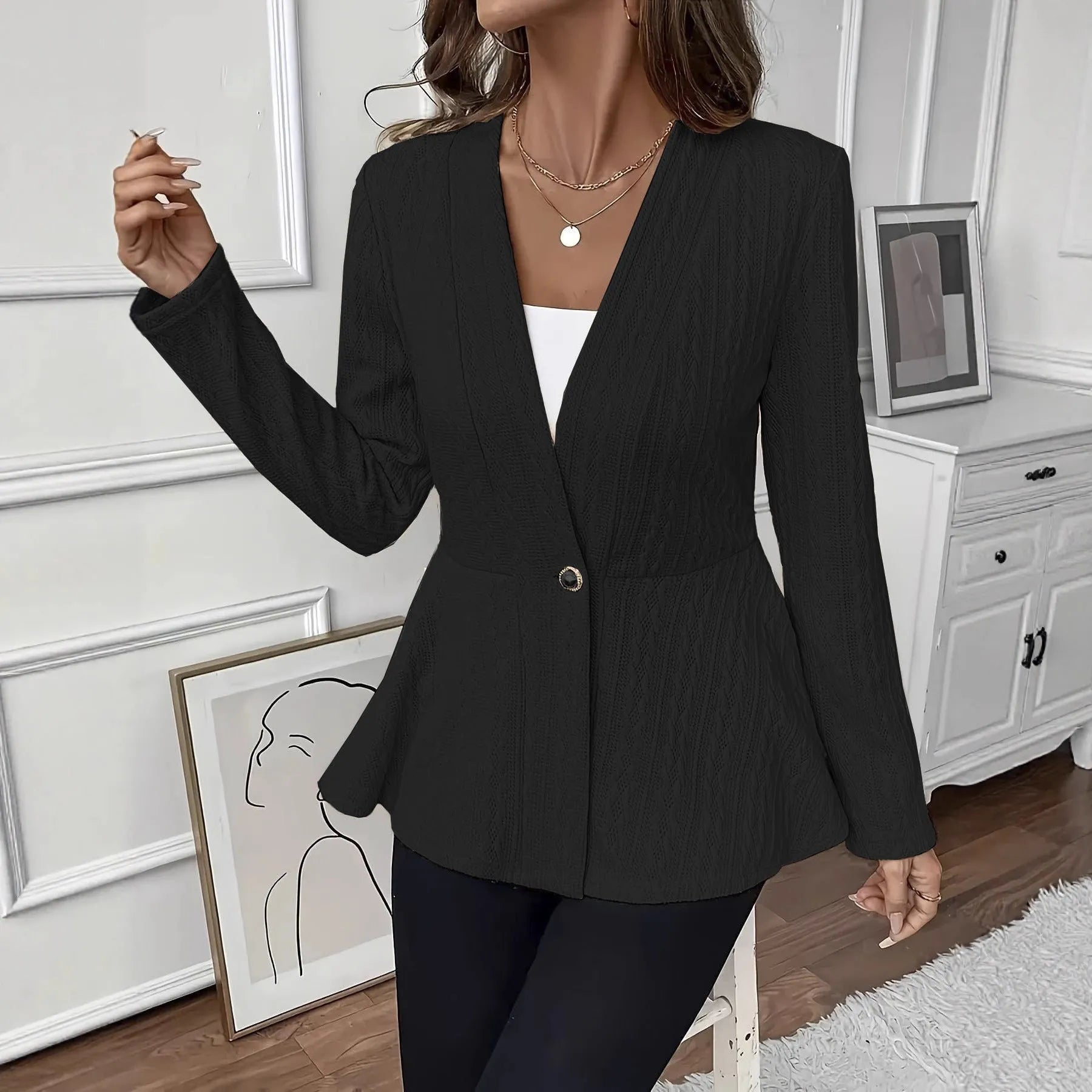 Women's apricot coloured knitted cardigan with jacquard pattern and one button, shown on a model.