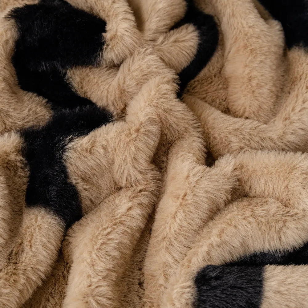 Zebra pattern flannel sofa slipcover in caramel colour, shown draped over a sofa.