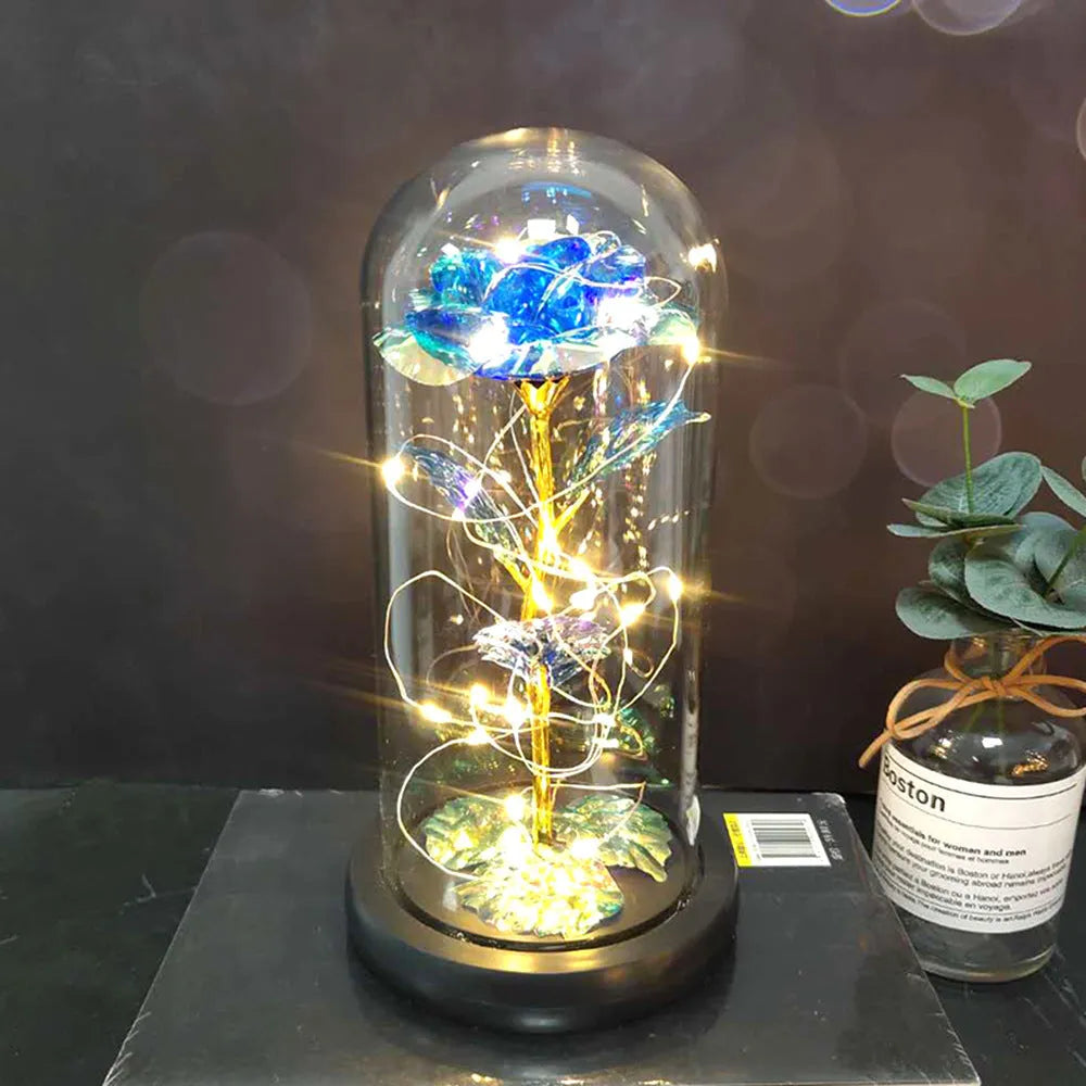LED rose ornament with silk flowers under glass shade, showing colour options on a wooden base.