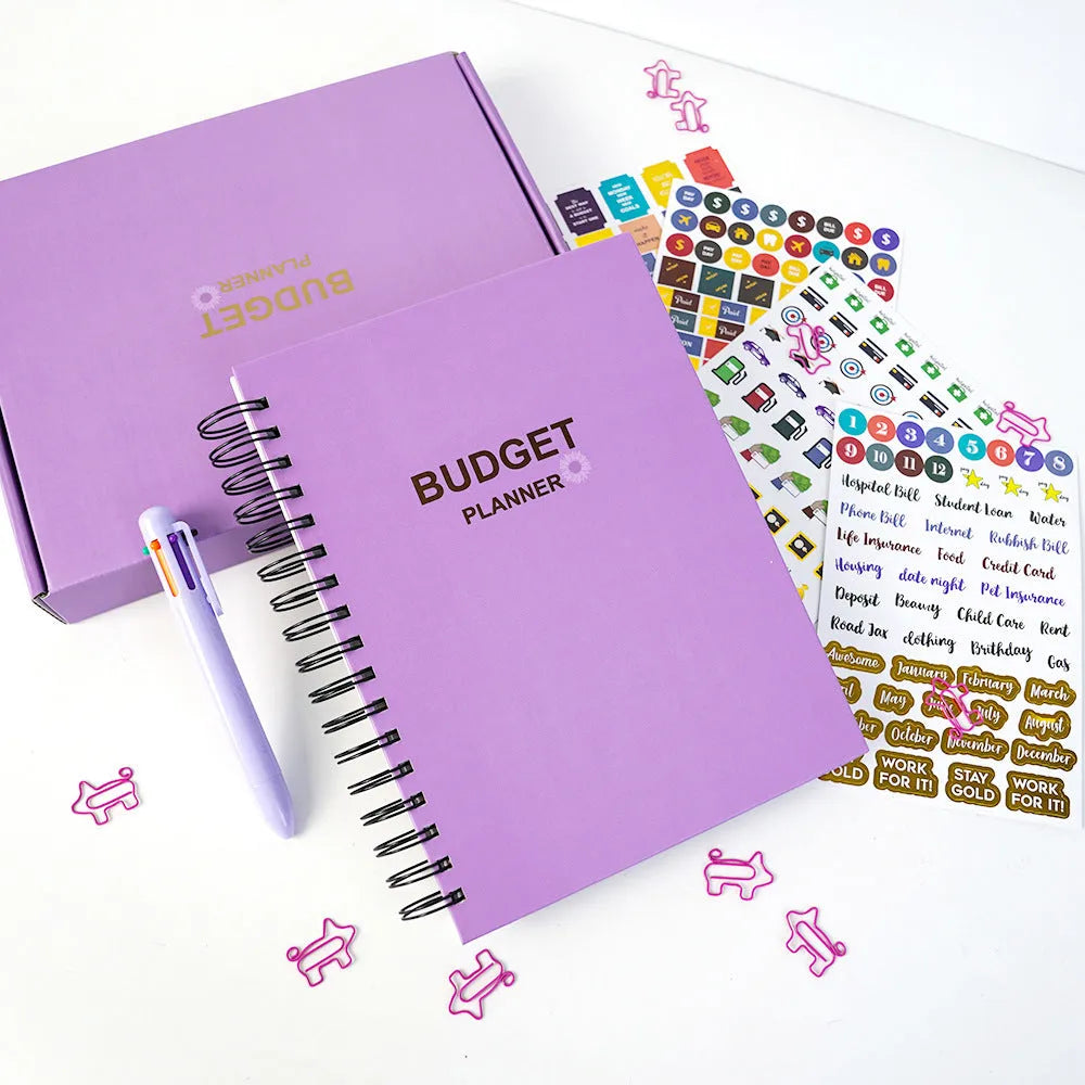 J12 purple coil-bound financial planning notebook with pen, stickers, and paper clips