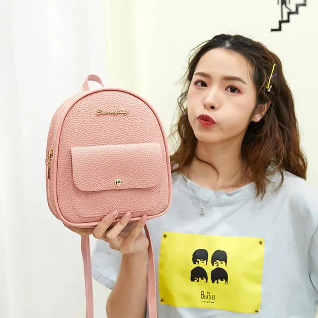 Small black PU leather women's shoulder backpack with zip, shown as a letter-style purse.