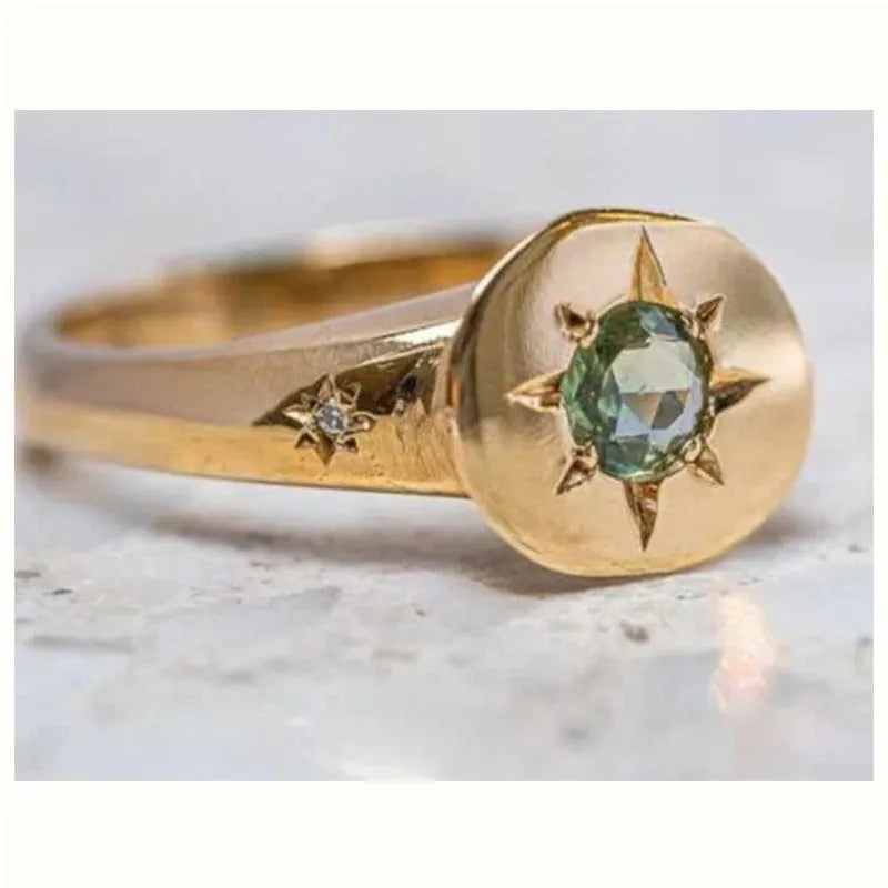 Gold star ring with oval zircon stone on an adjustable zinc alloy band.