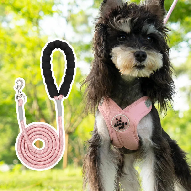 Blue polyester dog vest harness with an attached hand-held rope for walking.