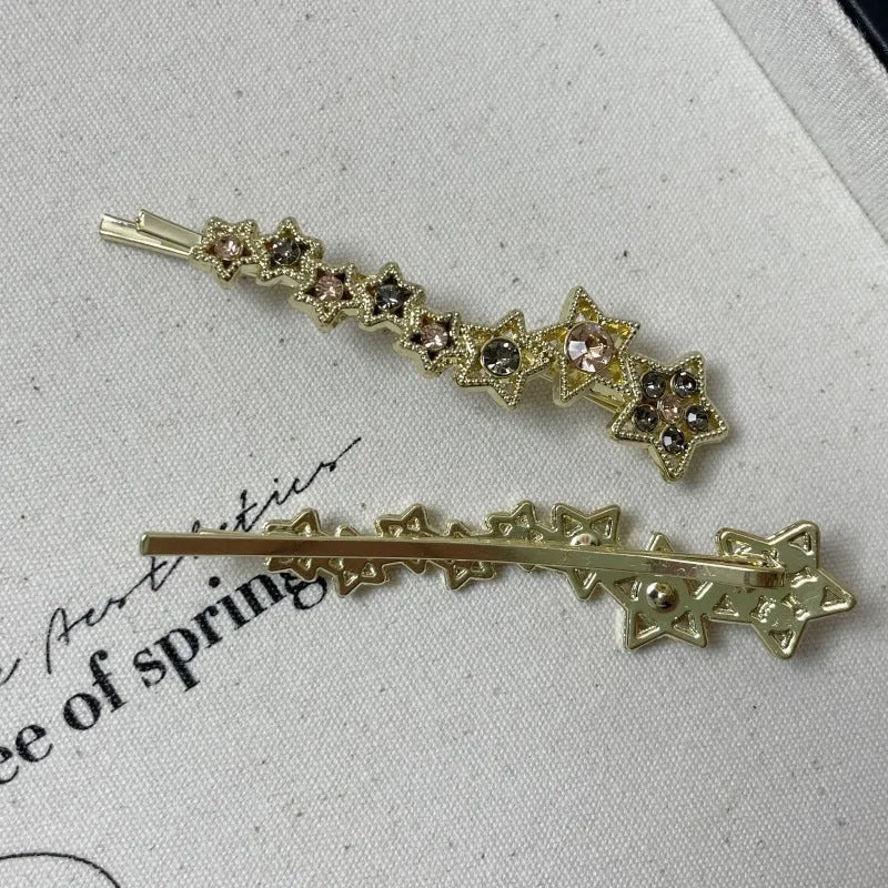 Gold hair barrette clip with rhinestone star detail on side