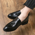 Men's black slip-on business casual shoes with a tassel detail on the artificial PU upper
