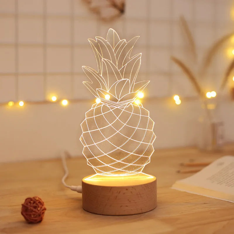 Cartoon pineapple-shaped USB night light with wood and acrylic casing on a table.