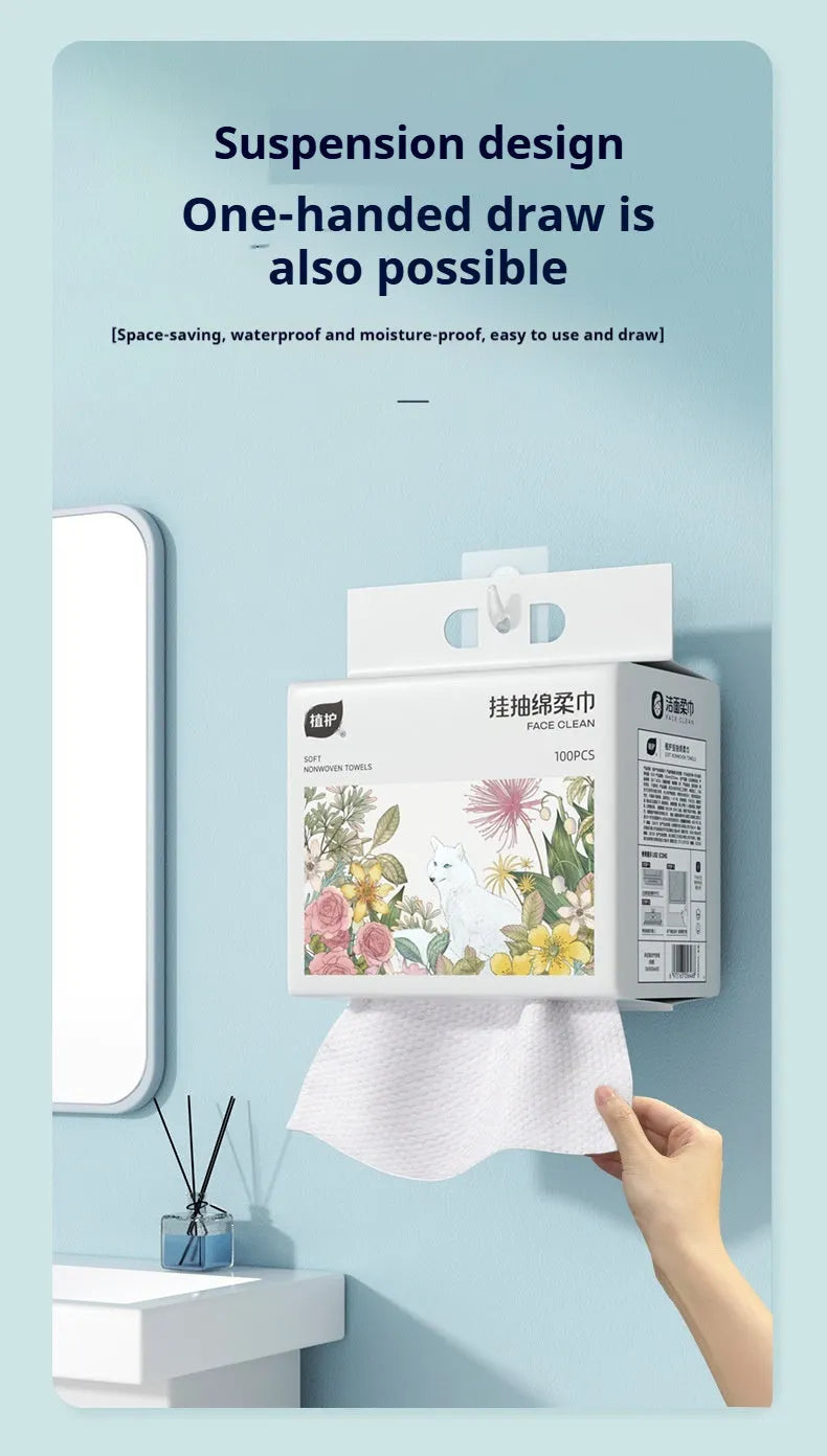 Roll of 100 disposable white face cloths on a hanging dispenser.