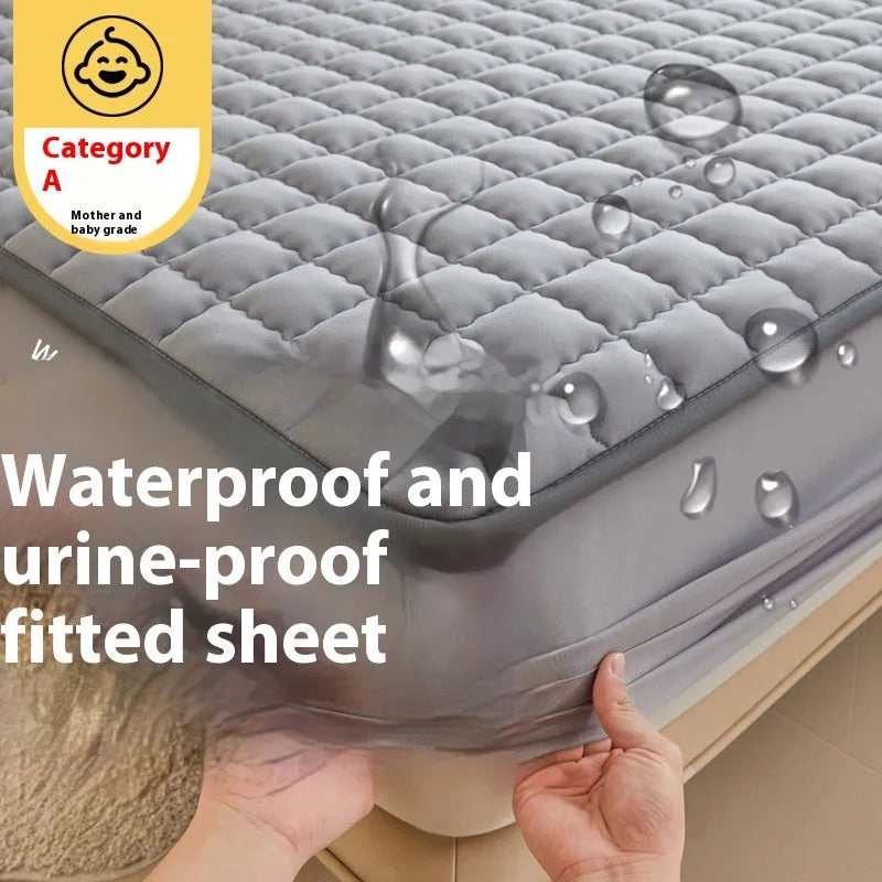 Class A waterproof fitted sheet in light grey colour, shown fitted neatly on a mattress.