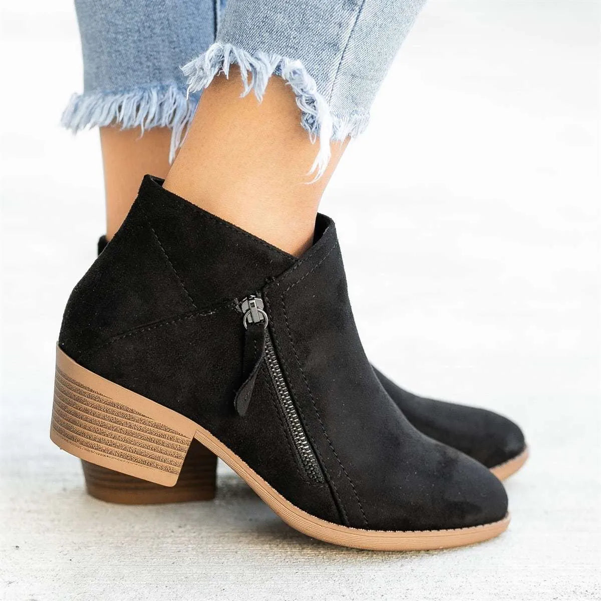 Blue women's suede ankle boots with a chunky heel and a side zip closure on a white background.