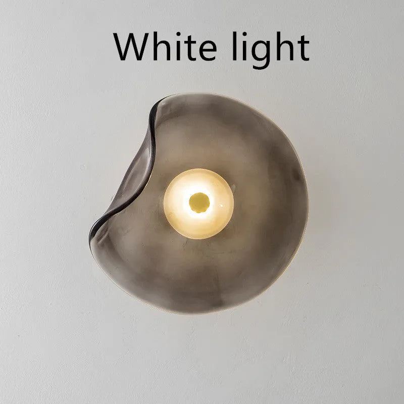 Round glass wall lamp in cognac colour with diffused lighting for bedroom bedside decoration