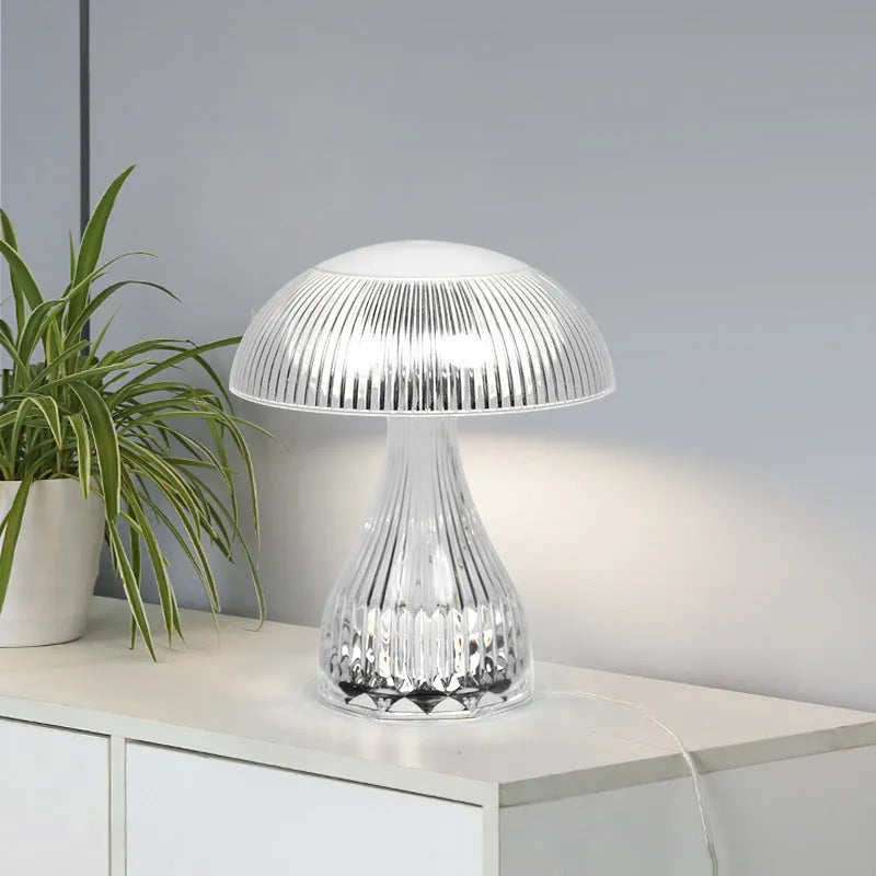 White rechargeable touch control bedside lamp with acrylic shade on a table.