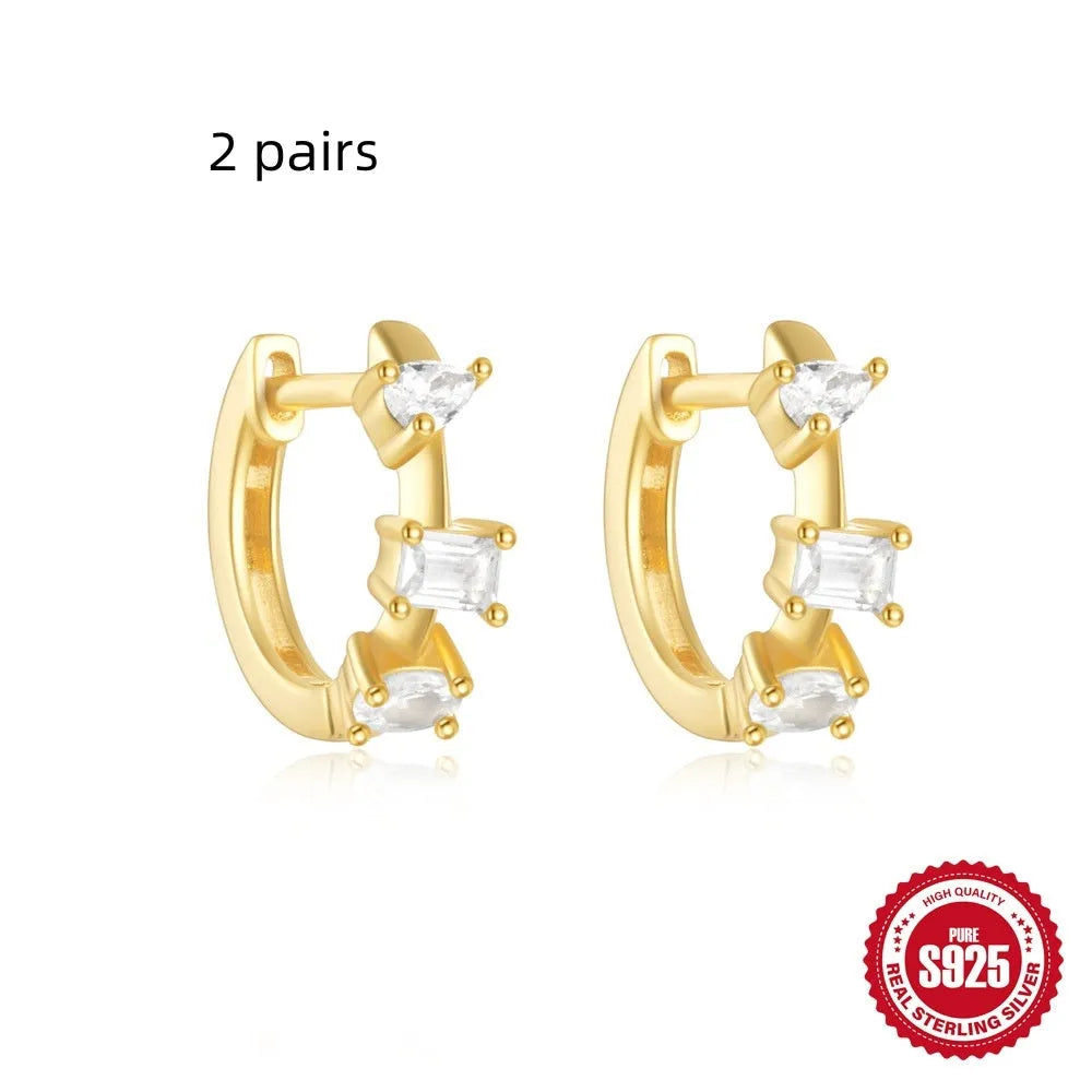 Small round geometric sterling silver stud earrings with a diamond shape, available in gold or silver finish.