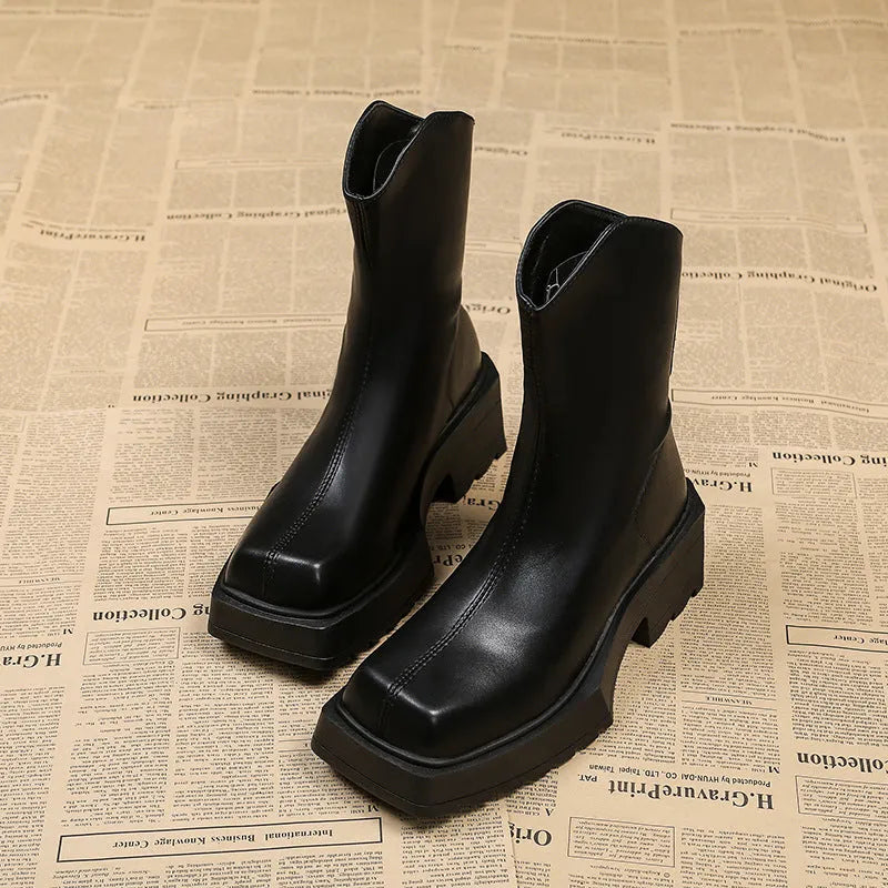Women's black platform Martin boots with square toe, chunky heel, and back zipper on a white background.