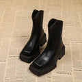 Women's black platform Martin boots with square toe, chunky heel, and back zipper on a white background.