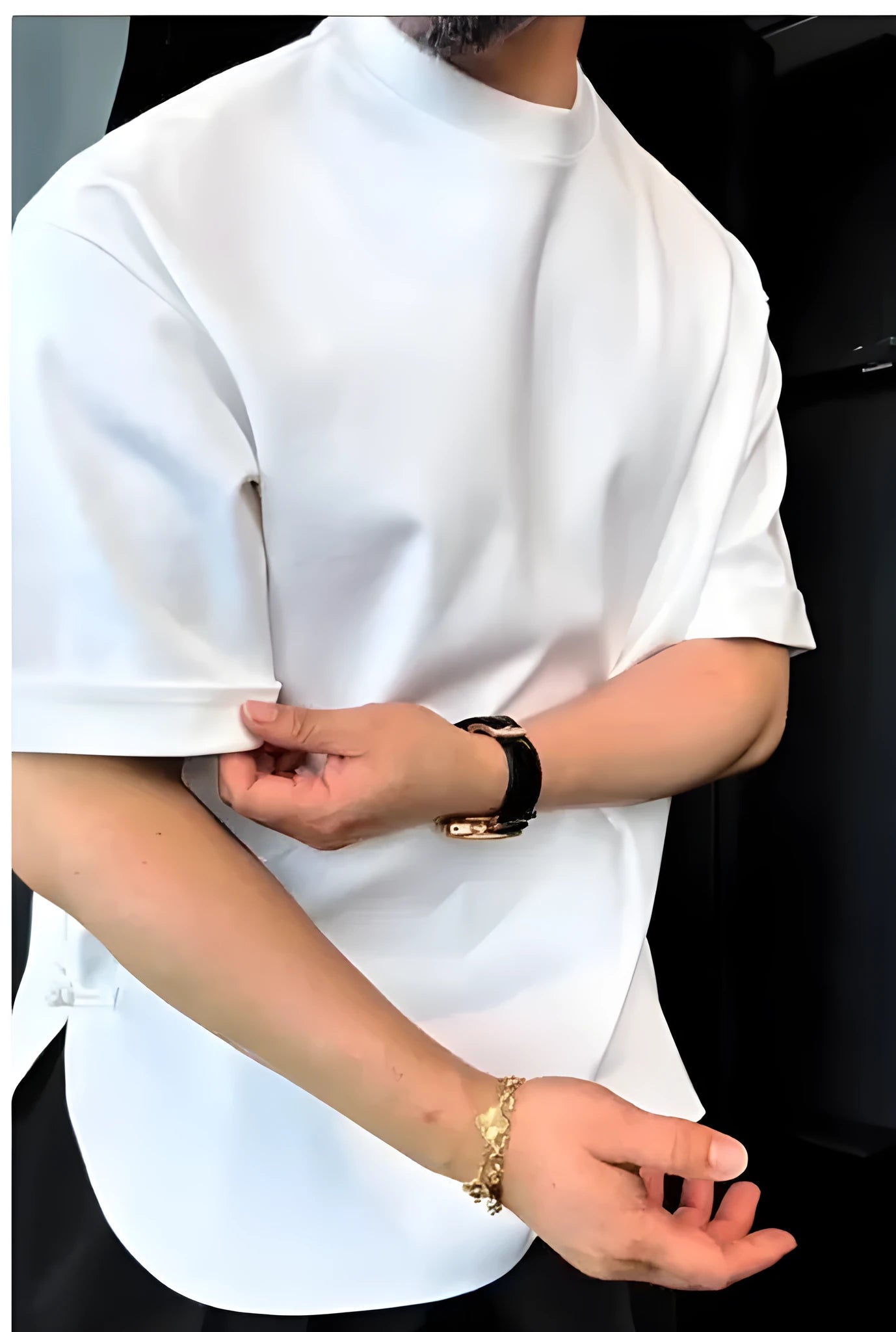 White men's buttoned round neck t-shirt with an extended hem on a model.
