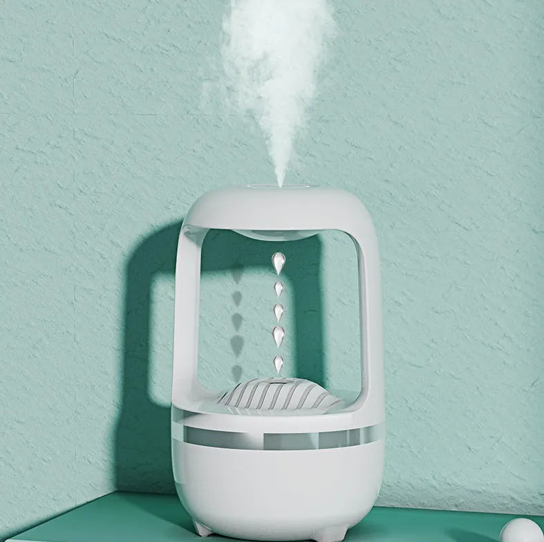 White anti-gravity water droplet humidifier with aromatherapy function on a desk.