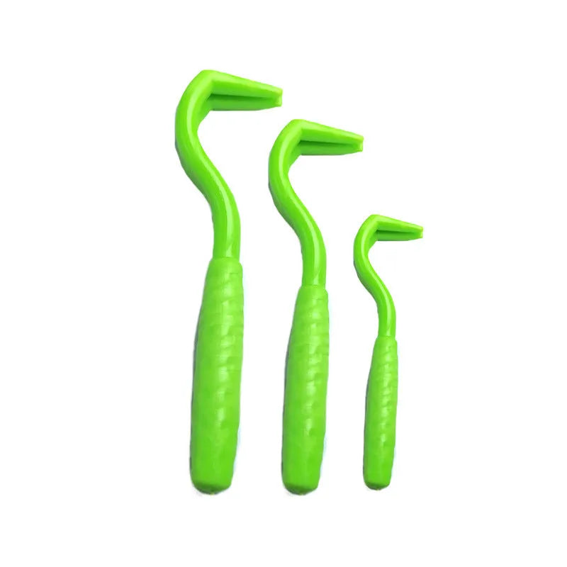 Set of three coloured ABS plastic tick removal hooks for dogs on a white background.