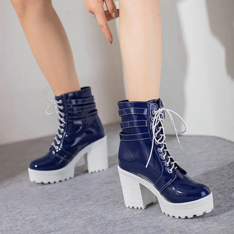 Women's black ankle boots with thick heel, round toe, and front lace-up on a waterproof platform sole.